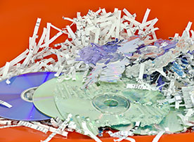 Image.  Shredded paper documents and CDs